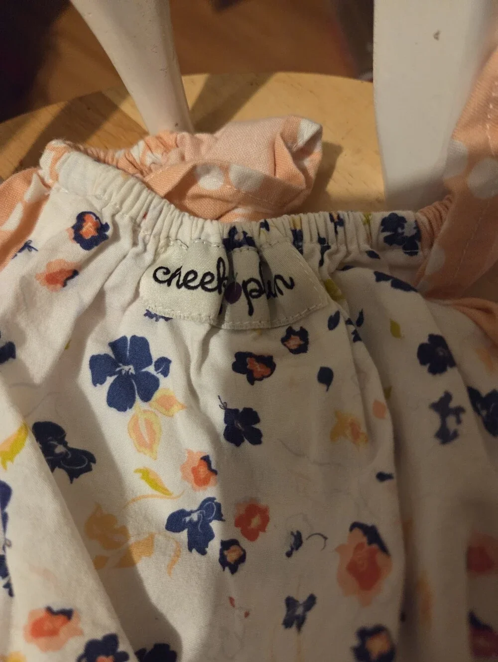 cheeky plum White Floral Romper with Navy & Peach Accents